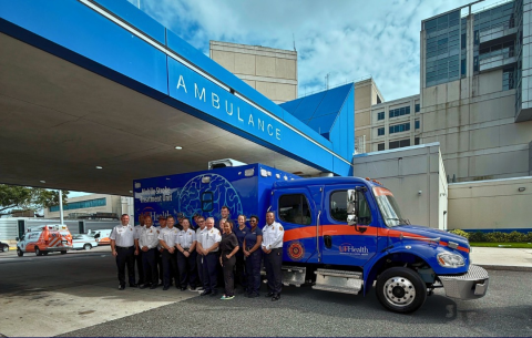 Camden County Fire Rescue and Jacksonville Fire Rescue Department personnel stand in front of the Mobile Stroke Unit.