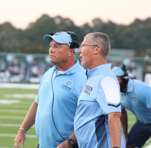 Camden County High School’s new head football coach, Jon Lindsey, left, discusses an on-field adjustment with former football coach Jeff Herron during a 2023 football game. Lindsey was named the new football coach of the program Friday.