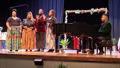 The Duke Fisher Singers perform Tuesday morning during a Thiokol plant explosion memorial at Camden County High School’s auditorium.