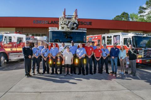 Kingsland Deputy Fire Chief Bill Carreira, left, Alex Gonzalez, seventh from left, Kingsland Mayor Grayson Day Jr., fourth from right, and others are surrounded by the rescue team from Kingsland Fire Rescue Station 4.