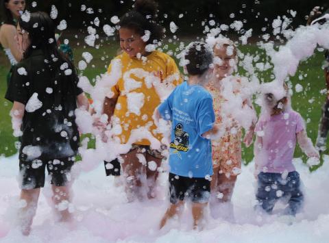 Children play in the foam machine Tuesday during Camden Family Connection’s annual Party in the Park at Crooked River State Park.