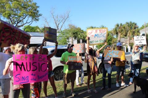 People stand outside Fernandina Beach City Hall in support of live music downtown. City commissioners passed first reading of a law they hope will allow music to be performed while avoiding disturbing downtown residents.