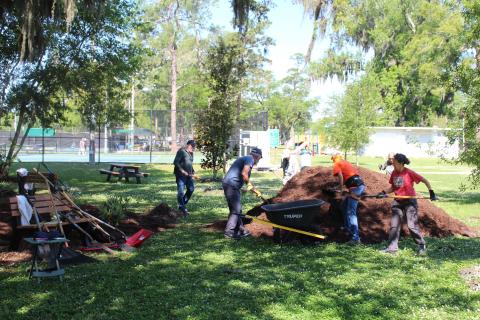 Volunteers spread mulch and put finishing touches on Volunteers Grove, a garden in Central Park honoring volunteers in the community that will be dedicated Thursday. 