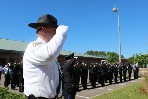 Nassau County law enforcement officers salute the fallen heroes at Nassau County Law Enforcement Memorial Plaza.