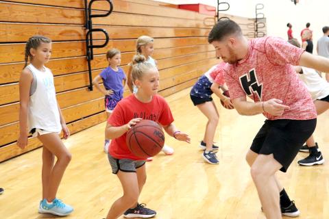 Children ages 7-12 hone their basketball drills as part of the Camp Saunders activities hosted by Hilliard Middle-Senior High School Coach Myron Saunders and the Class 1A state runner-up Flashes boys basketball team in the gym July 15. Forty-four kids participated in the four-day camp, learning the proper way to dribble the ball, defensive tactics and how to hone their skills at the basket. The campers received participation certificates at the conclusion of the camp. 