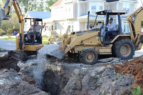 Callahan Public Works employee Ryan Everly unloads gravel recently near water and sewer lines along Dixie Avenue as co-worker Marty Johnson directs him. Photo by Kathie Colgrove