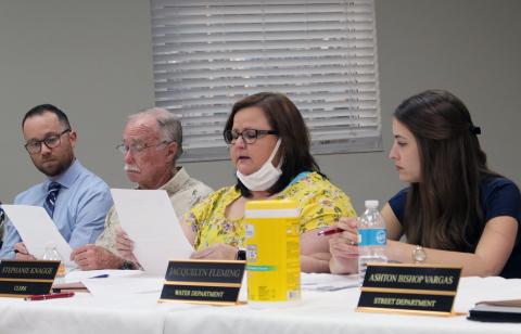 Town Clerk Stephanie Knagge reads her letter of resignation aloud Monday evening. Her resignation is effective March 31. Town Council President Ken Bass reads along in the background as interim Town Attorney Christian Waugh listens.