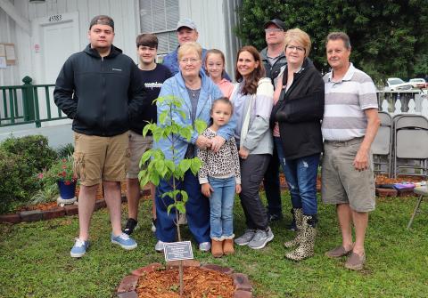 The family of West Nassau Historical Society co-founder Jan Johannes gathers around a dogwood tree planted in his memory during the society’s 16th annual Railroad Day Festival April 17. 