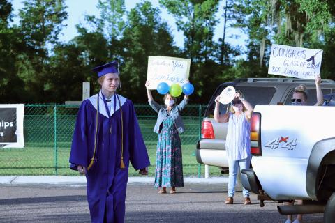 Sonshine Christian Academy held commencement at Crossroads Family Worship Center May 17. Around 20 people attended the ceremony due to social distancing. Afterward, educators and friends held up congratulatory messages outside. 