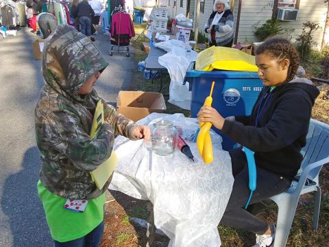 Cousins Dixie Conekin and Aliya Works volunteer at the Be the Change Northeast Florida, Inc. clothing giveaway Saturday. The duo assists at the non-profit’s events often. 