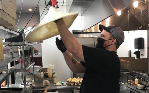 Josh Sheppard has worked for Coastal Pizza for just under four years, coming with the company from Yulee to their new Amelia Island location. Twirling pizza dough into the air, he said he has fun at work, adding, “I love what I do.” JULIA ROBERTS/NEWS-LEADER
