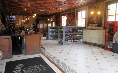 The Palace Saloon, above left, has been through fire, hurricanes, and Prohibition, and now is struggling to survive a global pandemic by operating as a liquor store where patrons can still purchase a gallon of the establishment’s signature Pirate’s Punch for takeout. JULIA ROBERTS/NEWS-LEADER