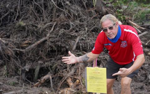 SUBMITTED photos Flora Parke resident Alan “Hupp” Huppmann points to a stop work order issued by the county after a crew began clearing land near his home. Huppmann was just one of the neighbors alarmed by the activity. SUBMITTED