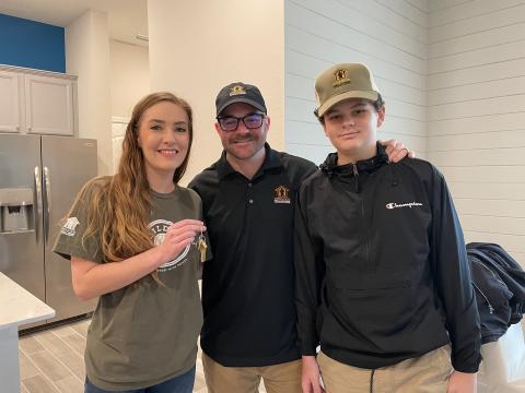 U.S. Marine Sgt. Bradley Thomas, and his wife, Kori Thomas, and son, Landon Thomas, celebrate the mortgage-free home they received from Lennar.
