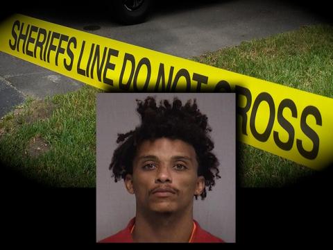 A mugshot of suspect Hicks over crime scene tape. NCSO