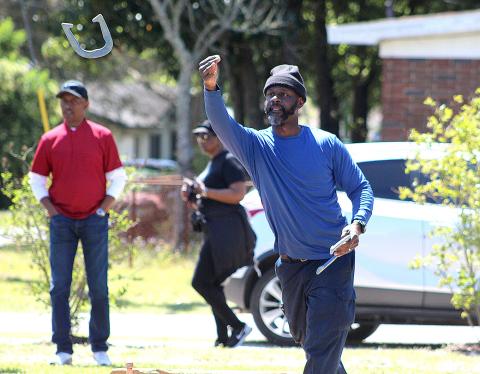 Teddy White competes in the inaugural horse shoe tournament Saturday at the MLK Jr. Center. He and teammate Everette Way took first place.