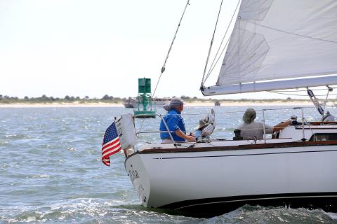 Sea Esta skipper Glen Stettler, at the helm on left, and crew keeping an eye on traffic and markers along the race course on Saturday.