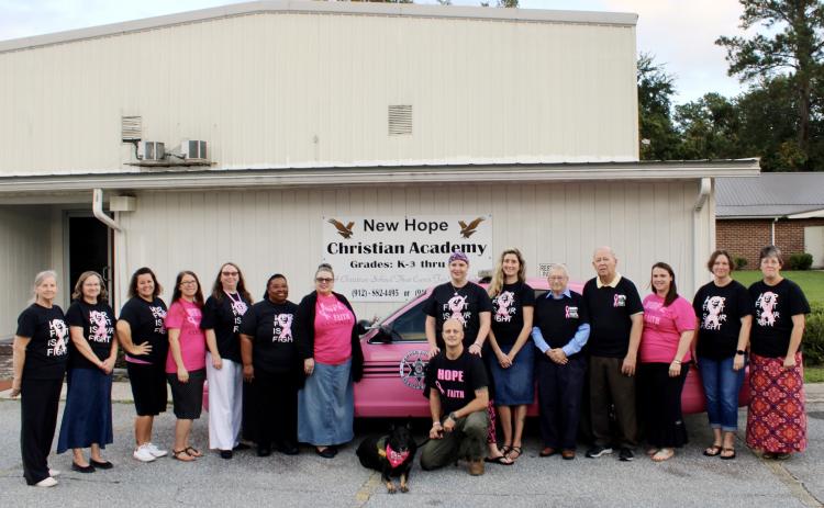 Natalie Furr (center) is facing a second diagnosis of breast cancer this year with support from her husband, county deputy Jerry Furr, his K-9 partner Bella and her coworkers at New Hope Christian Academy.