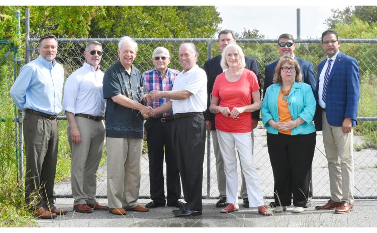 The change in ownership was celebrated on Wednesday as officials gathered for a key presentation ceremony at the gates of the Cumberland Inlet development in St. Marys. The sale of the property closed this week. Shown are (from left) Jacoby Development Inc. representative John Loudon, JDA executive director James Coughlin, master developer Jim Jacoby, JDA board member Burford Clark, bankruptcy trustee Mike Newsom, and JDA members Jeff Lockhart, Tonya Glazebrook, Jim Lomis, Rachel Baldwin and C.B. Yadav.