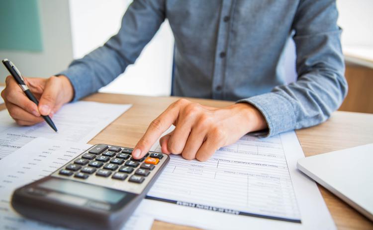 Citizen figuring taxes with a calculator