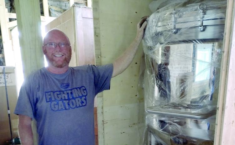 Brackish Beer Company's Jon Preble shows off a piece of equipment that will be used to brew beer in the craft beer joints new location on Osborne Street.