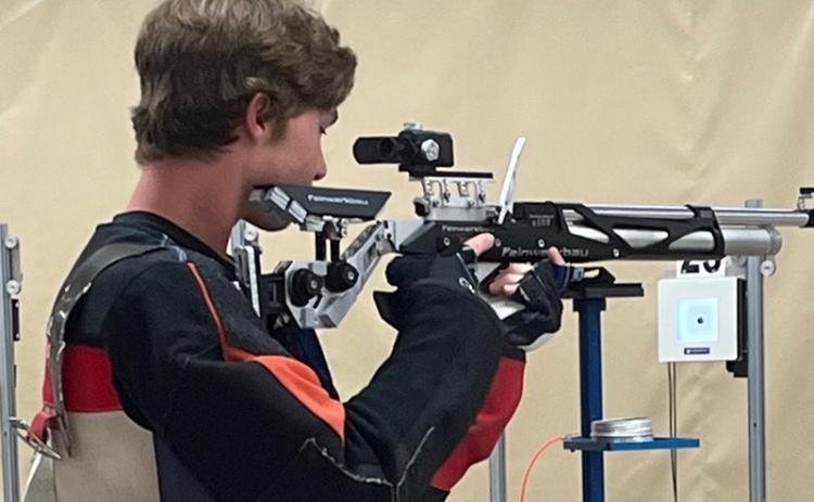 John Strassner takes aim during a riflery camp in Alabama. (Submitted photo)
