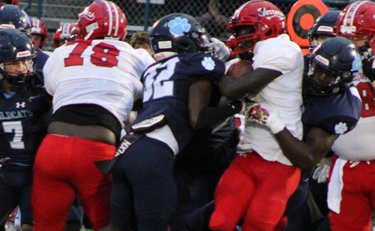 Glynn Academy running back Greg Peacock finds nowhere to go as several Wildcats converge on the tackle. (Andy Diffenderfer, Tribune & Georgian)
