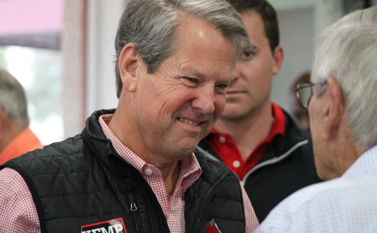 Gov. Brian Kemp speaks to a supporter prior to his breakfast rally in downtown St. Marys.
