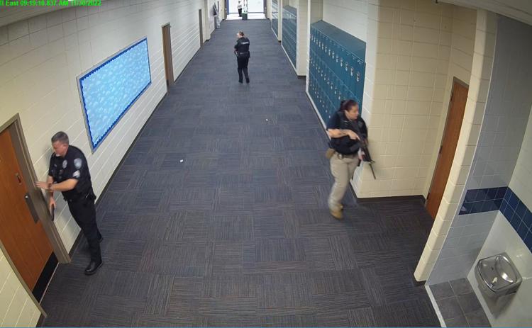 Still shots from security cameras inside Camden County High School show law enforcement officials searching the school for a shooter Nov. 30. Reports of a shooting at the school were a hoax.