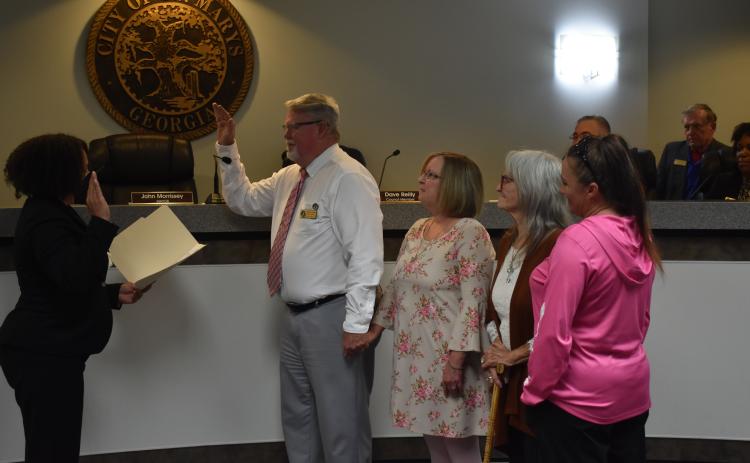 St. Marys City Clerk Deborah Walker-Reed, from left, issues the oath of office to newly elected  St. Marys Councilman Steve Conner. With Conner are his wife, Cheryl Conner, and the family of Danny Riggins, Anne Riggins and Dana Riggins Parker. Danny Riggins died in December after he was elected to the City Council.