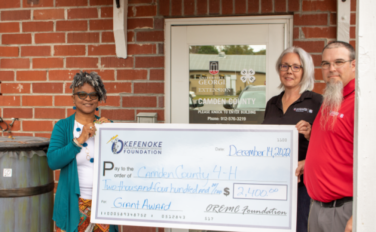 OREMC Foundation Trustee Sonya Walker presents a grant to Shawnie Sahadeo, 4-H Agent, and Shawn Clark, 4-H Educator, at Camden County 4-H to support Project Achievement.