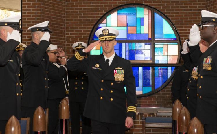 Cmdr. James Kepper IV, incoming commanding officer of the Ohio-class ballistic-missile submarine USS West Virginia (SSBN 736) Blue Crew, salutes the side boys during a change of command ceremony at the chapel onboard Naval Submarine Base Kings Bay.