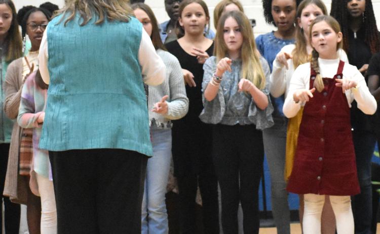 Woodbine Elementary School students perform a song Friday during the Thiokol Memorial Project’s 52nd anniversary of the deadly explosion at the Thiokol Chemical Factory.