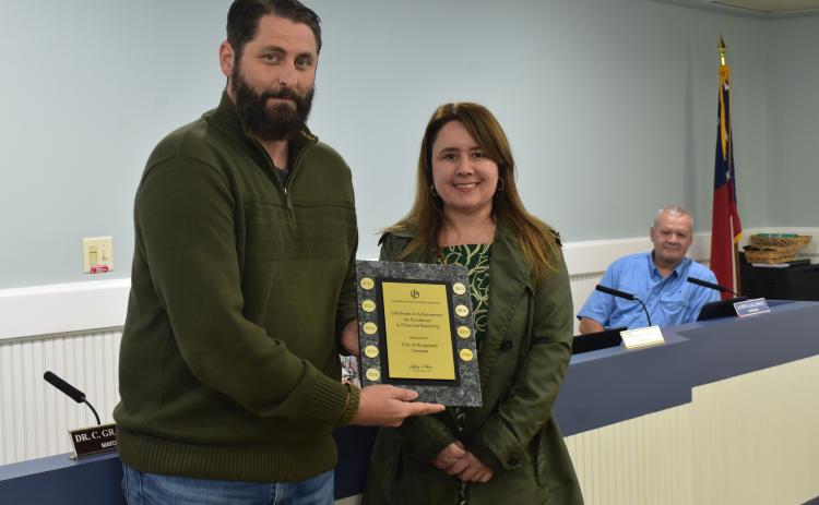 Kingsland Mayor Grayson Day, left, and Kingsland Finance Director Filiz Morrow show off the Government Finance Officers Association Certificate of Achievement for Excellence in Financial Reporting the city was awarded for the 18th consecutive year.