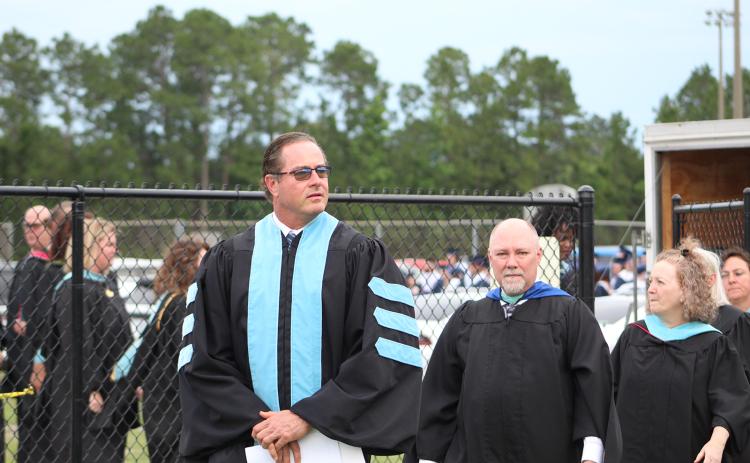 Camden County Schools Superintendent John Tucker, left, leads Camden County High School faculty onto the field during the 2021 graduation ceremony at Chris Gilman Stadium.