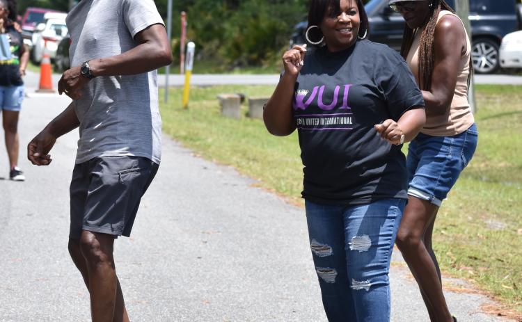 Clifton Herbert Mitchell, Kingsland Councilwoman Kristy Chance and Peggy Kennedy dance to the music.