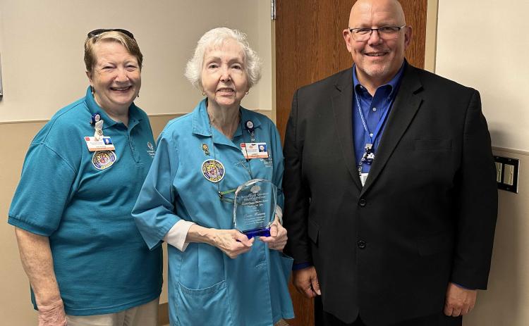 Southeast Georgia Health System Camden Campus Volunteer Services President Kathleen Worthing, left, and Camden Campus Vice President and Administrator Glenn Gann, right, honor the volunteer of the year, Lansie Manning.