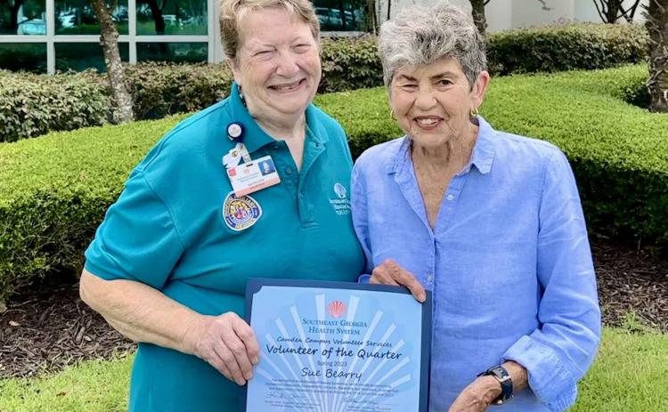 Camden County Volunteer Services President Kathleen Worthing, left, presents Sue Bearry with the Camden Campus Spring Volunteer of the Quarter award.