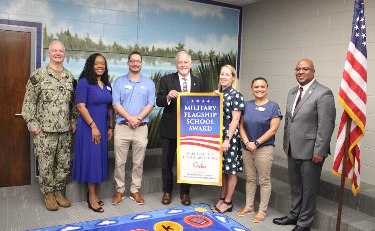 Naval Submarine Base Kings Bay Commanding Officer Capt. Chris Bohner, Camden County Schools Superintendent Tracolya Green, Camden County Board of Education Chairman Jonathon Blount, Georgia Superintendent of Schools Richard Woods, Mary Lee Clark Elementary Principal Rika Dow, Camden school board member Allison Murray and Georgia Board of Education member Nicholas Ellis celebrate Mary Lee Clark’s designation as a Military Flagship School Award winner.