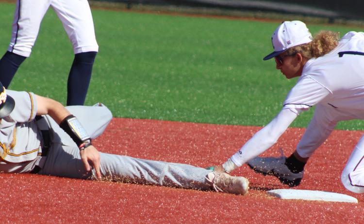 Camden County infielder Gavyn Nelson stretches for a tag attempt on Richmond Hill’s Noah Stone. (Andy Diffenderfer, Tribune & Georgian)