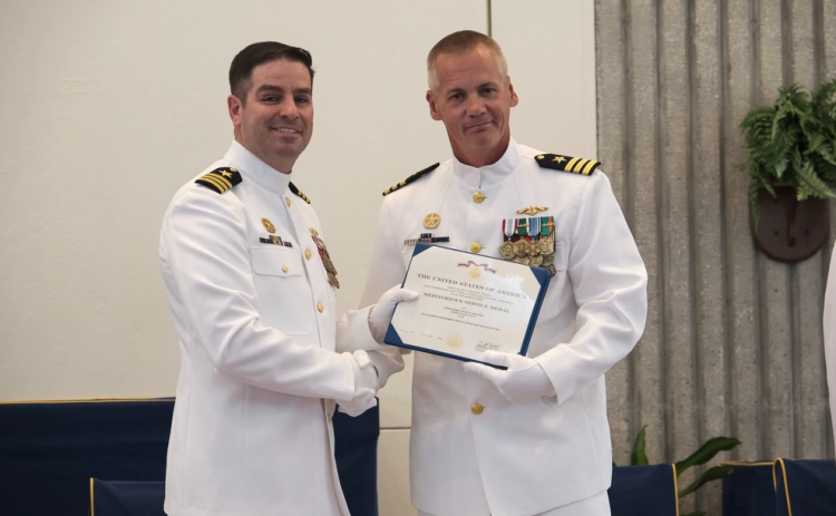 Cmdr. David Burke, deputy commodore, Submarine Squadron 20, right, awards Cmdr. Steven Dykstra the Meritorious Service Medal before relinquishing command of Ohio-class ballistic-missile submarine USS Wyoming (SSBN 742) (Blue) to Cmdr. Robert Moreno, during a change of command ceremony aboard Naval Submarine Base Kings Bay.