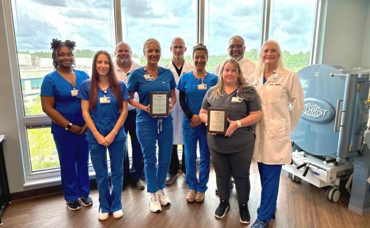 Camden Campus Wound Care Center employees Camille McGowan, Danielle Garza, Jim Hendrix, Ashley Holland, Benjamin Bograd, Soraya Williams, Damon Brantley, Jennifer Bailey and Donna Geiger share the National Award for Excellence in Wound Healing.