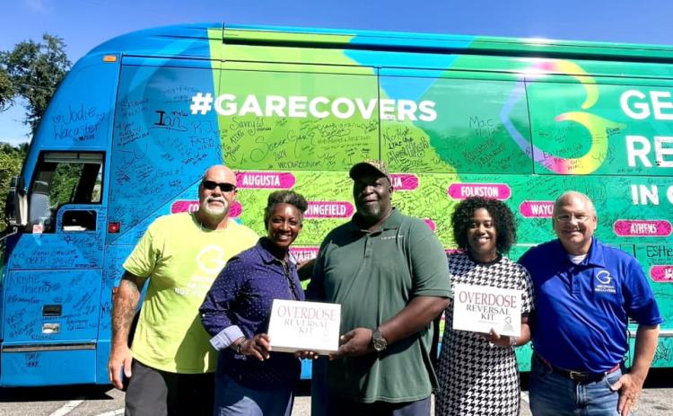 The Georgia Recovers Bus Tour recently visited Woodbine. Georgia Recovers Bus Tour manager Jon Langston, Woodbine Mayor Kizzi Knight, Jimmie Cohen, City Administrator Samantha Jackson and Georgia Council for Recovery policy advisor Jeff Breedlove show off the two Narcan kits donated to the city of Woodbine.