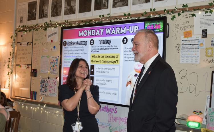 Camden Middle School sixth-grade English/language arts teacher Jenny Ritchotte, left, learns from Georgia Superintendent of Education Richard Woods that she’s been named a top-10 finalist for Georgia Teacher of the Year.