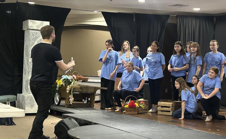 Saltwater Performing Arts’ “My Fair Lady” ensemble members rehearse a number with visiting guest director and Broadway actor Colin Anderson.