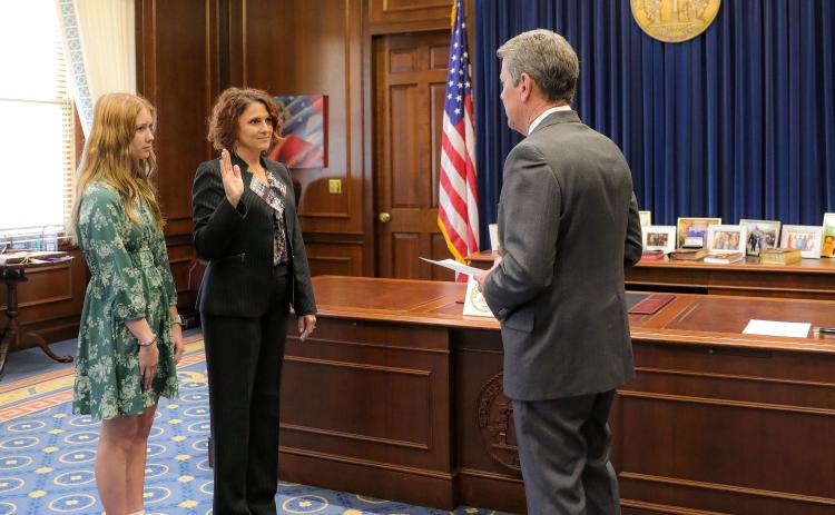 Gov. Brian Kemp, right, swears in Lydia Watkins, middle, dean of the School of Nursing and Health Sciences at the College of Coastal Georgia, to serve on the Georgia Board of Nursing. Watkins was accompanied by her daughter, Alyvia Watkins.