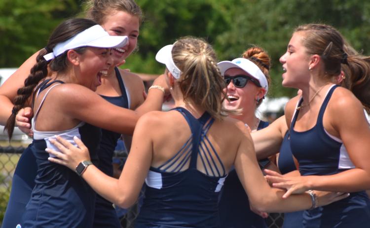 The Camden County High girls tennis team celebrates after defeating MIll Creek in a second-round state playoff Monday. The Lady Wildcats host South Forsyth in a Friday quarterfinal. (Andy Diffenderfer, Tribune & Georgian)