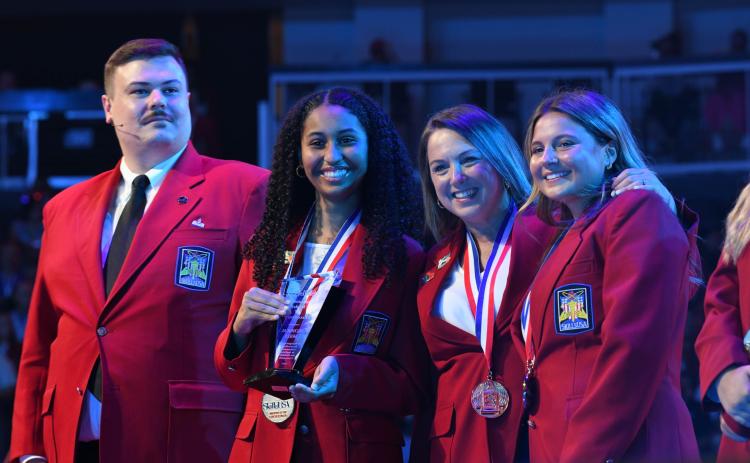 Camden County High School’s Rhiyana Revels, second from left, and Chloe Loper, far right, earned first place in the Models of Excellence-Technical Skills category during the SkillsUSA National Leadership Conference in June in Atlanta. With the two students are teacher Jennie Corse, second from right.