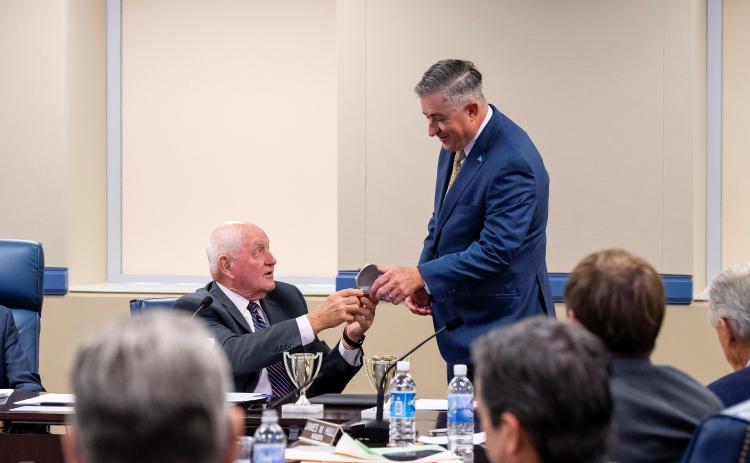 University System of Georgia Chancellor Sonny Perdue, left, presents College of Coastal Georgia President Johnny L. Evans Jr. with the Chancellor’s Cup at the USG Board of Regents meeting in August.