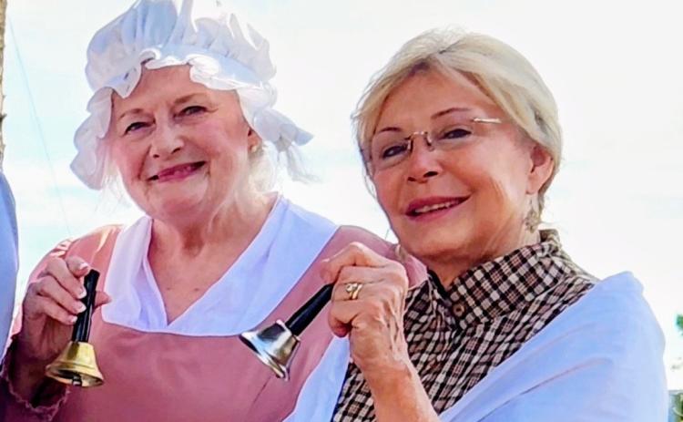 The Earl of Camden Chapter of the National Society of the Daughters of the American Revolution’s Pamela Kimes, left, and Maggie Williams, ring bells at a national bell ringing ceremony.